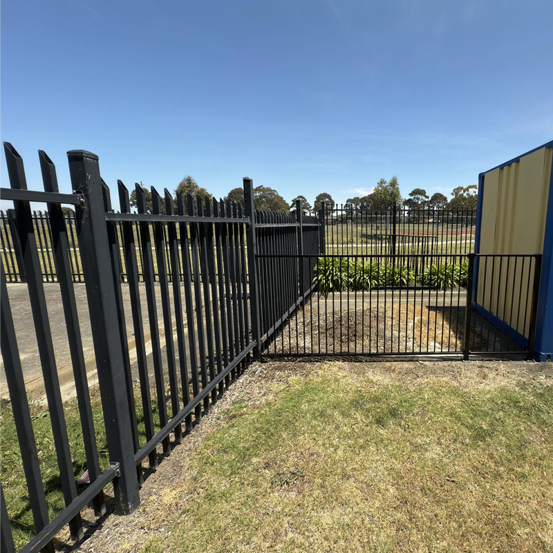 Black steel fence and gate around a grassed area