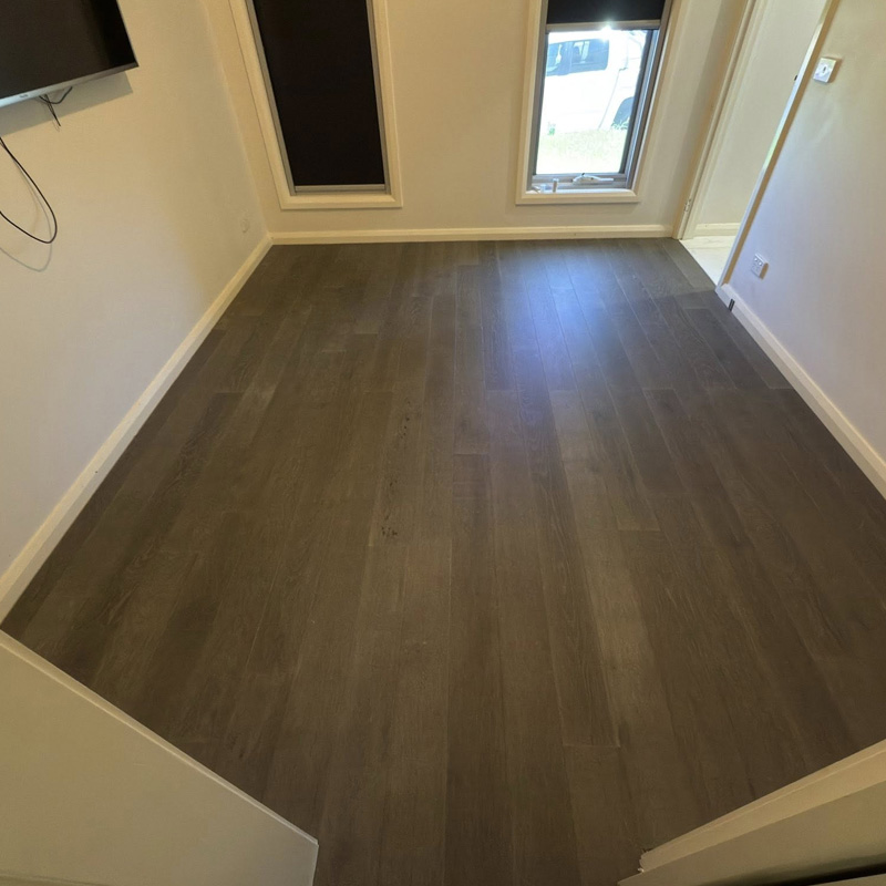 Dark timber-look flooring in an empty bedroom