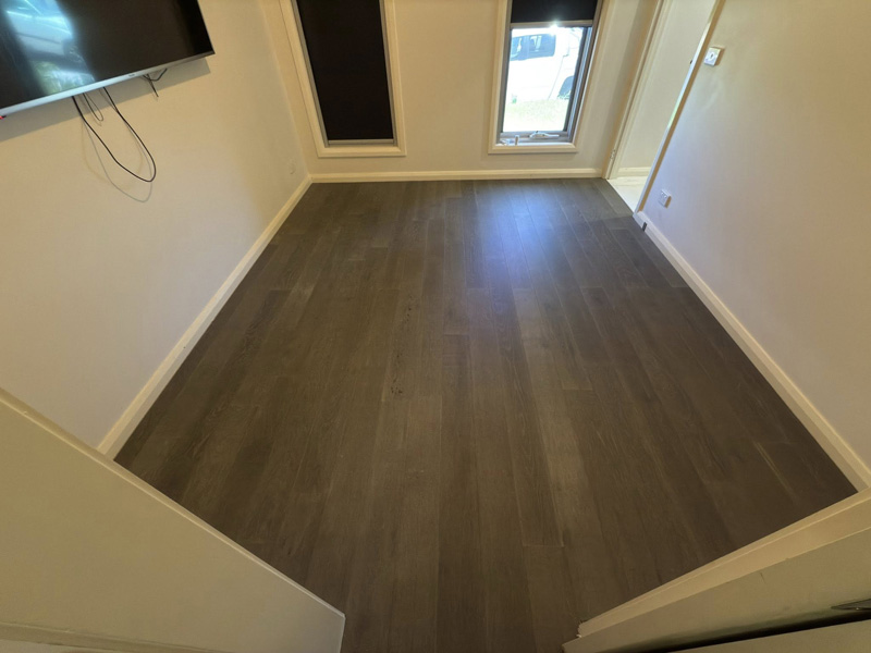 Dark timber-look flooring in an empty bedroom